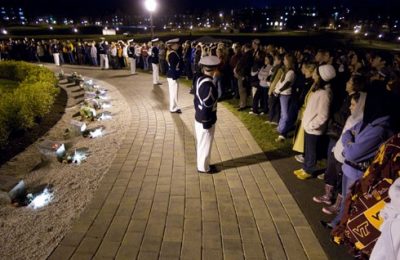 Members of the Virginia Tech Corps of Cadets and a crowd gather just before the lighting of the memorial candle.