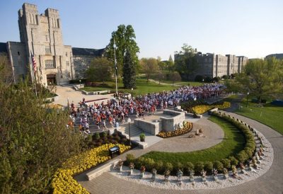 Runners passing Burruss Hall and the April 16 Memorial 