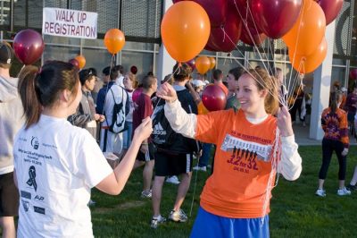 Runners passing out balloons prior to the start line of the 3.2 Run.